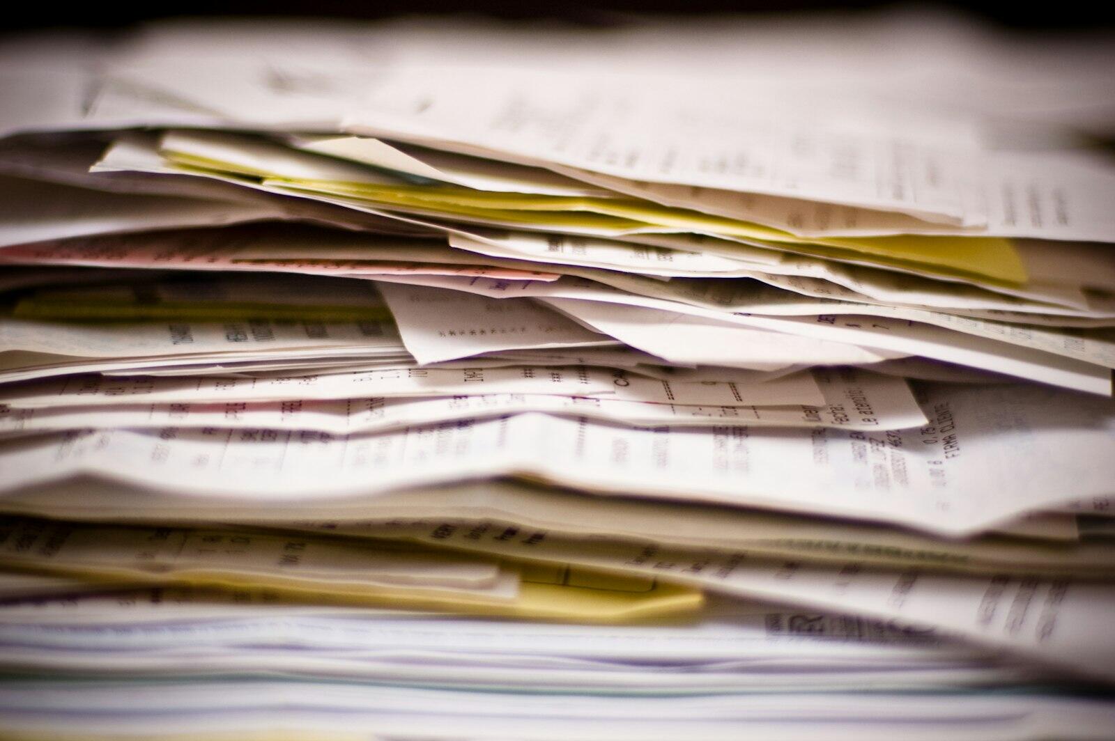 A close-up of a stack of documents and paperwork