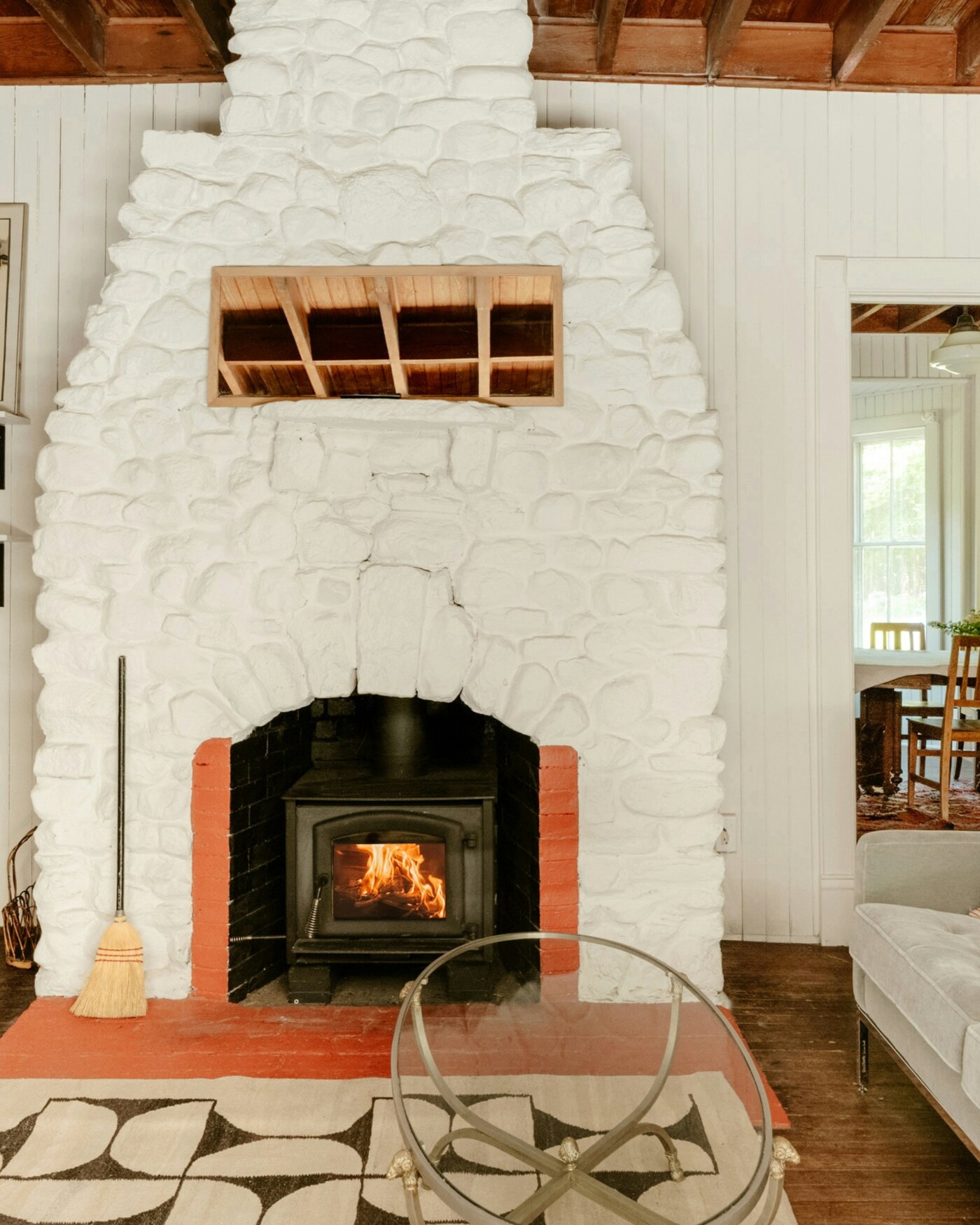 A warm, character-filled living room with a stone fireplace